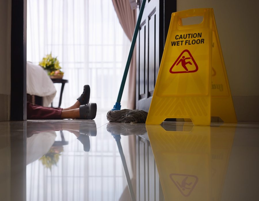 housemaid had accident at work while cleaning floor in hotel room. Side view, low angle